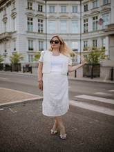 A blonde lady wears a modest two-piece set